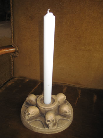 candle holder with ring of skulls