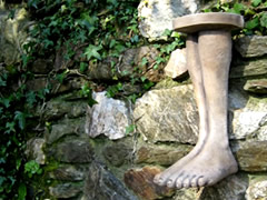 Feet statues that hang on a garden wall